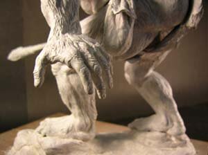 Closeup of head, left hand and dagger.